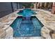 Close up of the mosaic spa and pool with elegant stone trim at 1874 Royal Majesty Ct, Oviedo, FL 32765