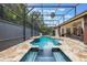 Screened-in pool features travertine tile decking and spa, offering the perfect outdoor oasis at 1874 Royal Majesty Ct, Oviedo, FL 32765