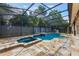 A stunning screened pool with travertine deck features a fountain and spa for relaxation and entertainment at 1874 Royal Majesty Ct, Oviedo, FL 32765
