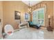 Serene sitting area with stylish furniture, a modern chandelier, and natural light at 1874 Royal Majesty Ct, Oviedo, FL 32765