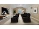 A well-lit home theater with comfortable seating, large television, and neutral decor at 1874 Royal Majesty Ct, Oviedo, FL 32765