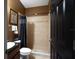 Neutral colored bathroom featuring a tiled shower and dark fixtures at 2237 Osprey Woods Cir, Orlando, FL 32820