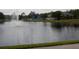 A scenic pond view with a fountain and glimpse of the community's playground and pool areas at 2237 Osprey Woods Cir, Orlando, FL 32820