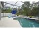 Screened-in pool area with lounge chairs and an umbrella, creating a relaxing backyard oasis at 2237 Osprey Woods Cir, Orlando, FL 32820