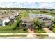 An aerial view of a home with a pond, water feature, and community at 2431 Tudor Rose Dr, Sanford, FL 32773