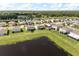 Beautiful aerial view of homes on waterfront lots with lush green lawns on a sunny day at 2431 Tudor Rose Dr, Sanford, FL 32773