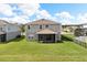 Beautiful backyard featuring a screened lanai, green grass and fencing at 2431 Tudor Rose Dr, Sanford, FL 32773