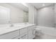 Bright bathroom features double sinks, white cabinetry, a soaking tub, and tiled shower at 2431 Tudor Rose Dr, Sanford, FL 32773