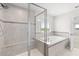 Modern bathroom featuring a tiled shower with a built-in bench and a luxurious soaking tub at 2431 Tudor Rose Dr, Sanford, FL 32773
