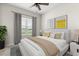Bright bedroom featuring a ceiling fan, large window with water view, and neutral décor at 2431 Tudor Rose Dr, Sanford, FL 32773