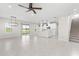 Open-concept living space with tile flooring seamlessly connects the living, kitchen, and stairwell at 2431 Tudor Rose Dr, Sanford, FL 32773