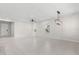 Spacious open living space with tile flooring, a modern light fixture, and ample natural light from the windows at 2431 Tudor Rose Dr, Sanford, FL 32773