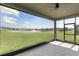 Enjoy serene views from this covered lanai overlooking a lush green lawn and water feature at 2431 Tudor Rose Dr, Sanford, FL 32773