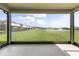 Enjoy serene views from this covered lanai overlooking a lush green lawn and water feature at 2431 Tudor Rose Dr, Sanford, FL 32773