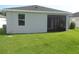 Exterior view of home, showing the screened in lanai and spacious backyard at 2451 Strandhill St, Orlando, FL 32824