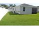Home's backyard shows fenced yard with well-manicured lawn at 2451 Strandhill St, Orlando, FL 32824