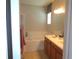 A well-lit bathroom features a double sink vanity, a soaking tub, and modern fixtures at 2451 Strandhill St, Orlando, FL 32824