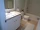 This bathroom features a white vanity, sink, toilet, and tub with tile flooring at 2451 Strandhill St, Orlando, FL 32824
