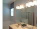 This bathroom boasts a double sink vanity, modern lighting, and a soothing color palette at 2451 Strandhill St, Orlando, FL 32824