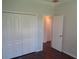 A room with a closet, entry door, hard wood floors, and light walls at 2451 Strandhill St, Orlando, FL 32824
