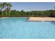 Relaxing community pool surrounded by lounge chairs and lush greenery at 2451 Strandhill St, Orlando, FL 32824