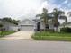 Beautiful single-story home with a two-car garage, front lawn and tropical landscaping at 2451 Strandhill St, Orlando, FL 32824