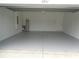 Spacious garage with a painted floor and walls for easy maintenance at 2451 Strandhill St, Orlando, FL 32824