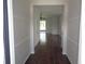 Inviting hallway with hardwood floors leading to a sunlit living area at 2451 Strandhill St, Orlando, FL 32824