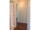 A hallway with modern wood flooring and white doors offers access to various rooms in the home at 2451 Strandhill St, Orlando, FL 32824