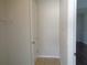 A view of the hallway showing a closed door and tile flooring at 2451 Strandhill St, Orlando, FL 32824