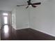 Hardwood floors, neutral paint colors, and a ceiling fan feature in this living room at 2451 Strandhill St, Orlando, FL 32824