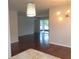 Bright living room with hardwood floors, modern lighting, and sliding glass doors to a screened patio at 2451 Strandhill St, Orlando, FL 32824