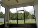 Screened in patio with view of the lawn and trees at 2451 Strandhill St, Orlando, FL 32824