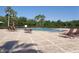 Outdoor community swimming pool with sun loungers and lush tropical landscaping at 2451 Strandhill St, Orlando, FL 32824