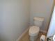 A clean, standard toilet in a neutrally decorated powder room for basic sanitation and convenience at 2451 Strandhill St, Orlando, FL 32824