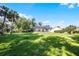 Large backyard with green grass and mature trees provides plenty of space for outdoor activities and relaxation at 2487 River Tree Cir, Sanford, FL 32771