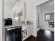 Bar area with a wine fridge, marble countertop, and custom cabinetry at 2487 River Tree Cir, Sanford, FL 32771