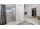 Bathroom featuring a tiled walk-in shower, a tub, and a view into the large walk-in closet at 2487 River Tree Cir, Sanford, FL 32771