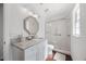 Elegant bathroom showcasing a marble countertop, decorative mirror, and glass-enclosed shower at 2487 River Tree Cir, Sanford, FL 32771