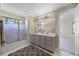 Cozy bathroom features a shower-tub combo and a gray vanity with great lighting at 2487 River Tree Cir, Sanford, FL 32771