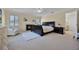 Cozy bedroom with a fireplace, plush armchair, and natural light streaming through plantation shutters at 2487 River Tree Cir, Sanford, FL 32771