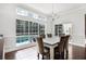 Bright dining room with a large window overlooking the pool, and a chandelier at 2487 River Tree Cir, Sanford, FL 32771