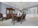Elegant dining room showcasing a wooden china cabinet, ornate dining table, and a stylish chandelier at 2487 River Tree Cir, Sanford, FL 32771