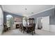 Formal dining room features a fireplace, chandelier, and a large wooden china cabinet for elegant entertaining at 2487 River Tree Cir, Sanford, FL 32771