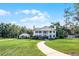 Traditional home on expansive lawn with mature trees exudes a sense of refined elegance and charm at 2487 River Tree Cir, Sanford, FL 32771