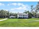 Sprawling home with manicured lawn, mature trees, and charming outbuilding exudes timeless appeal at 2487 River Tree Cir, Sanford, FL 32771
