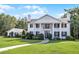 Impressive home featuring white columns, black shutters, and immaculate landscaping creates a grand entrance at 2487 River Tree Cir, Sanford, FL 32771
