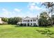 Expansive lawn and mature trees surround stately home with classic charm and curb appeal at 2487 River Tree Cir, Sanford, FL 32771