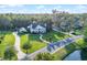 Stunning white mansion with manicured lawn, lush trees, and winding driveway creates an inviting estate at 2487 River Tree Cir, Sanford, FL 32771