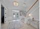 Welcoming foyer featuring a chandelier, staircase with wood railing, and elegant decor at 2487 River Tree Cir, Sanford, FL 32771